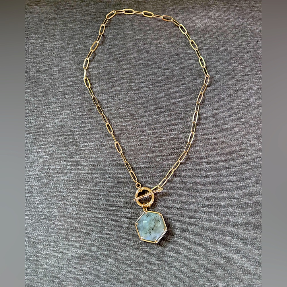Gold chain necklace with natural stone emblem